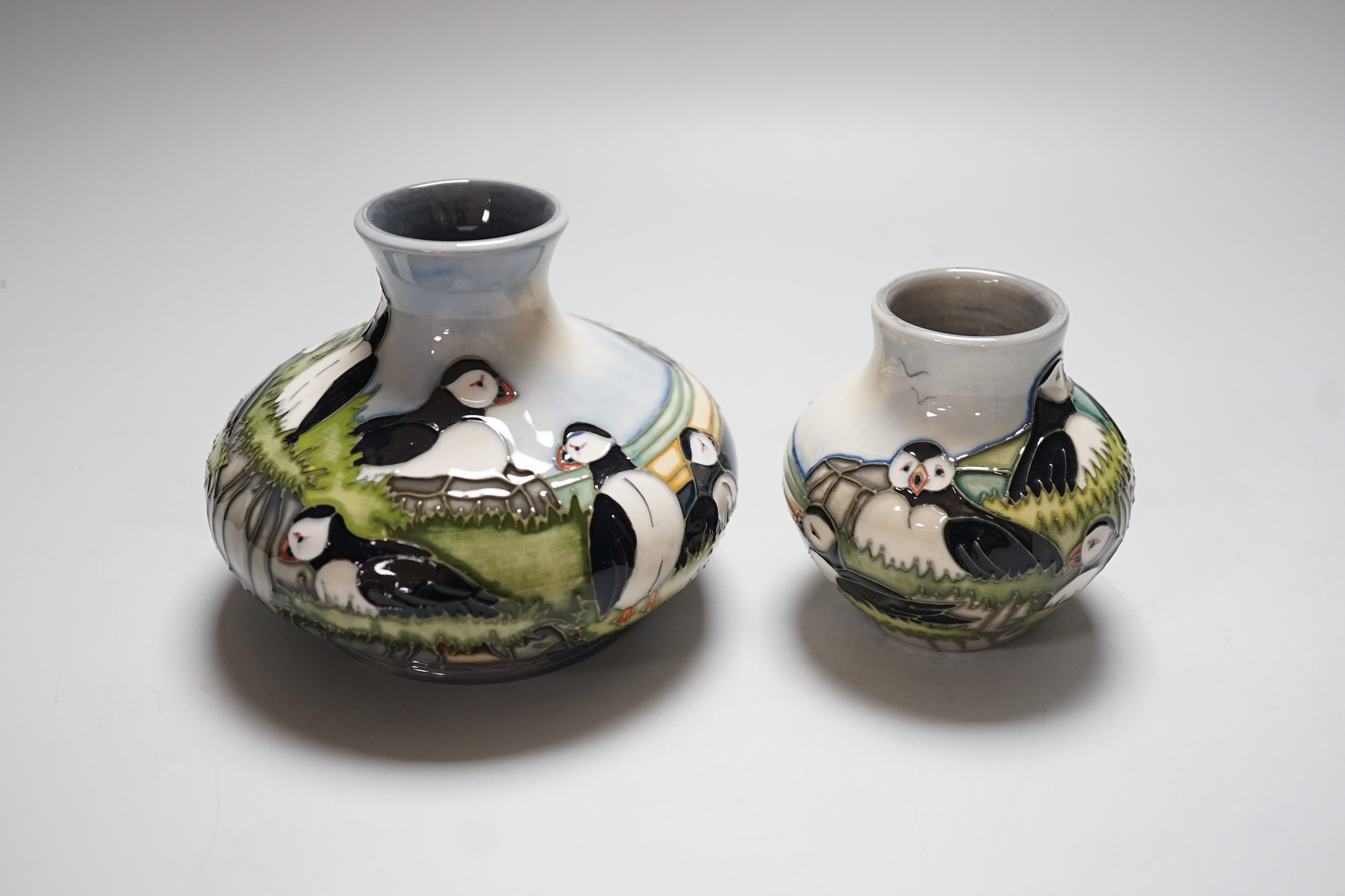 Three boxed Moorcroft ‘Puffin’ ceramics: a squat vase, a smaller vase and a dish, squat vase 11cms high